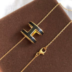 ??MIRA?¡¥HM CLIC BLACK ENAMEL GOLD NECKLACE